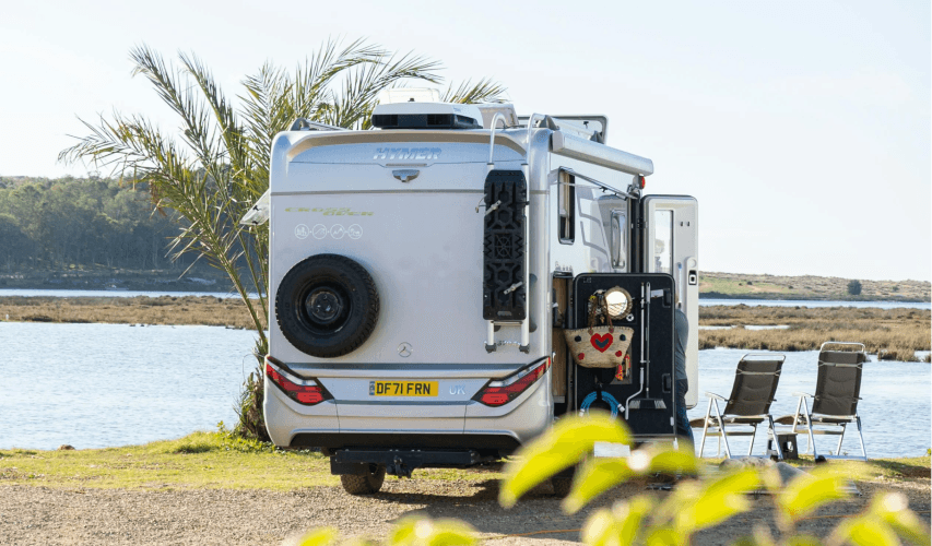 A camper van next to a lake
