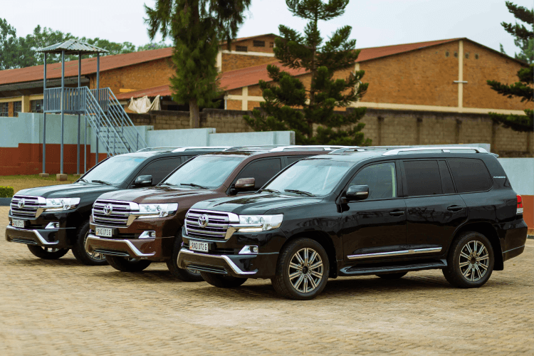 A row of 3 dark colored 4x4 cars